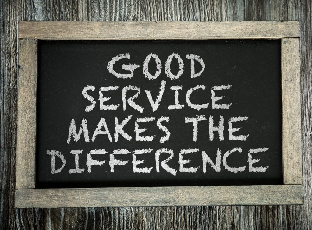 Good customer service is important. Image shows a chalk board with the words good service makes the difference. 