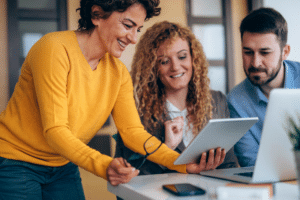 Three people working on improving thei digital journeys with feedback.