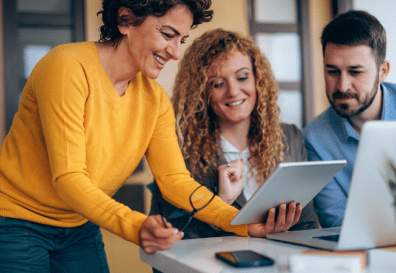 Three people working on improving thei digital journeys with feedback.