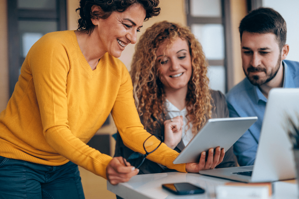Three people working on improving thei digital journeys with feedback.