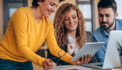 Three people working on improving thei digital journeys with feedback.